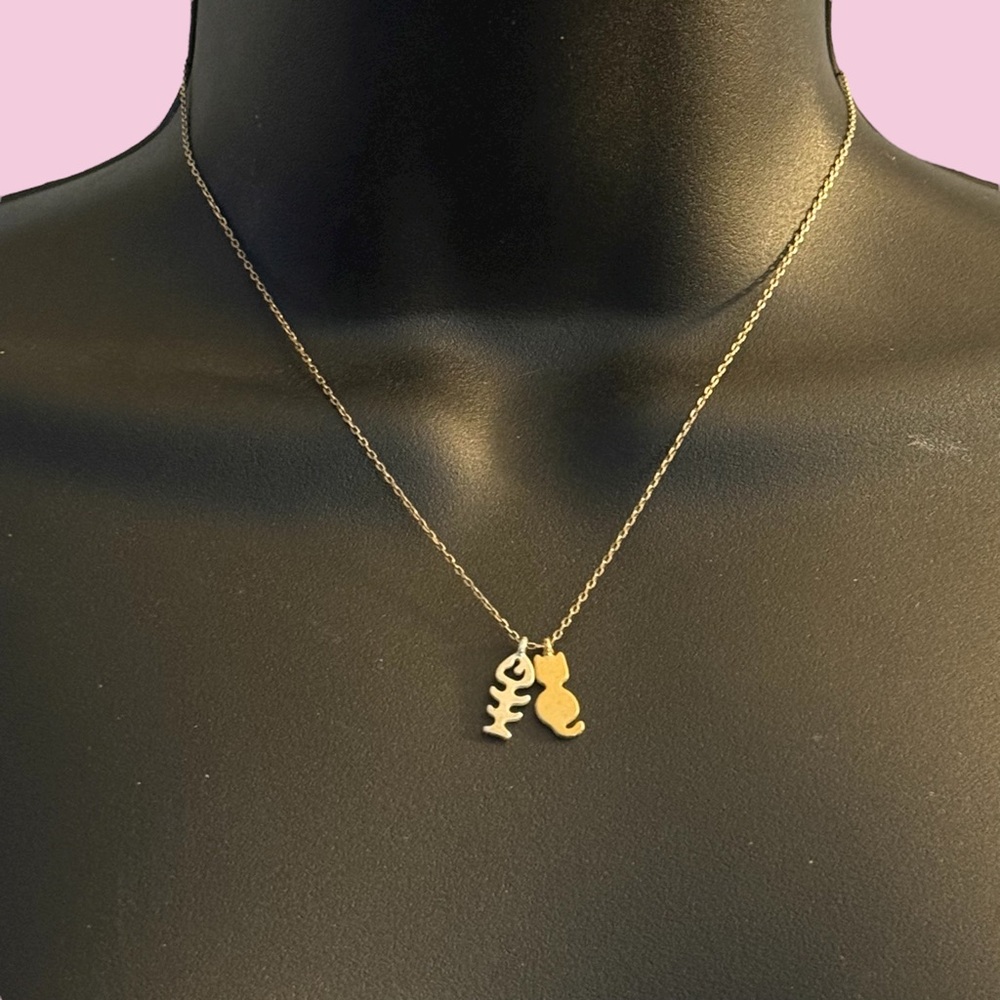 Dainty gold tone cat charm and fish skeleton necklace